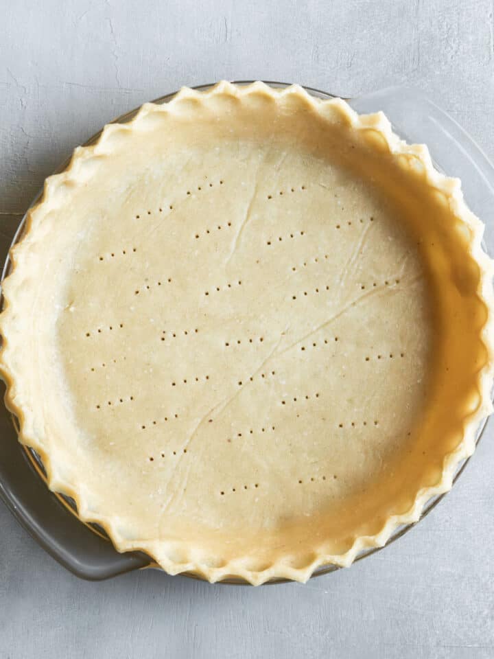 overhead view of crimped unbaked crust in a pie plate.