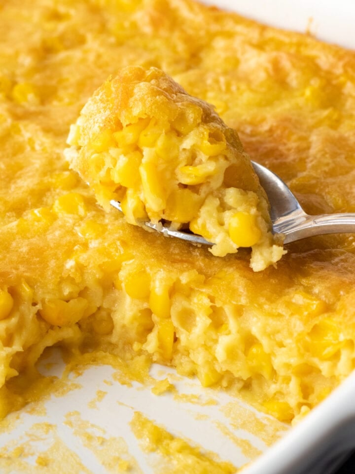 creamy corn pudding in a white baking dish.