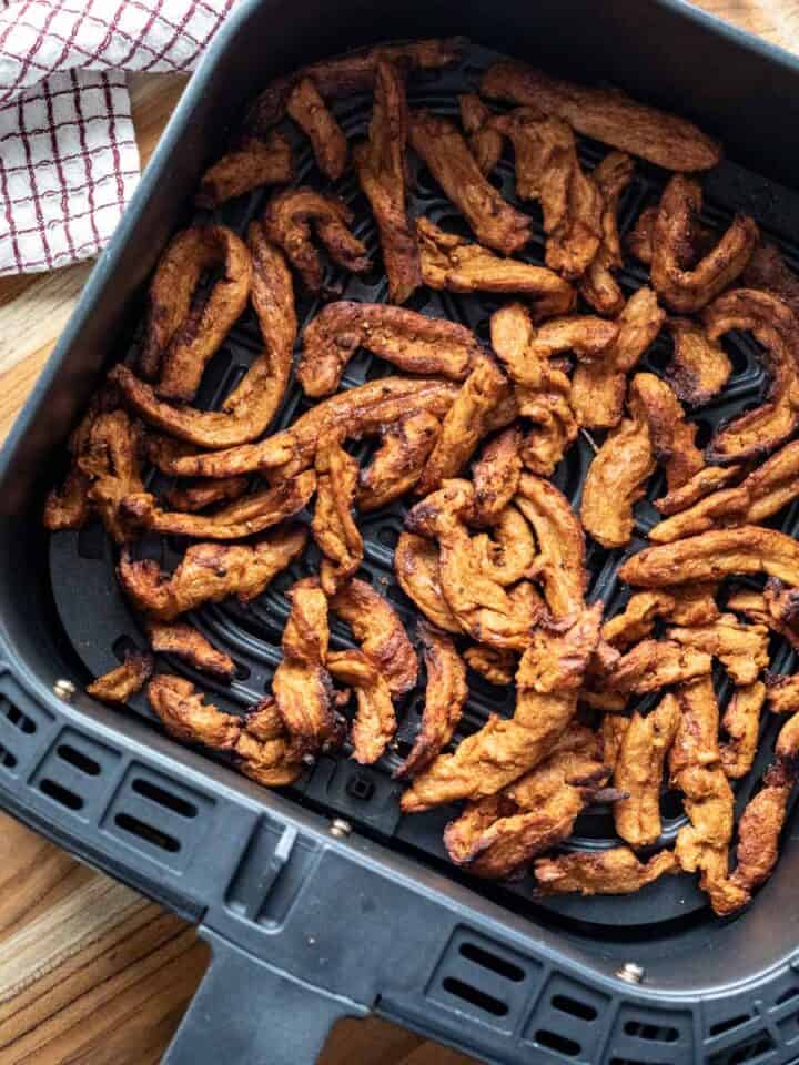 freshly air fried soy curls inside air fryer basket.