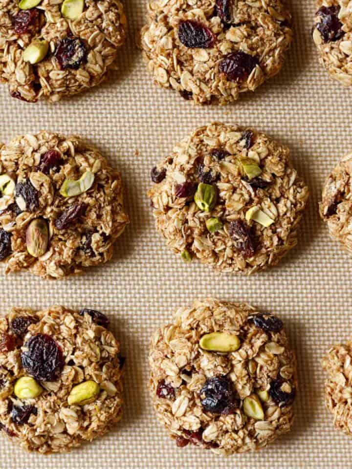 Baked applesauce oatmeal cookies on a silicone baking mat.